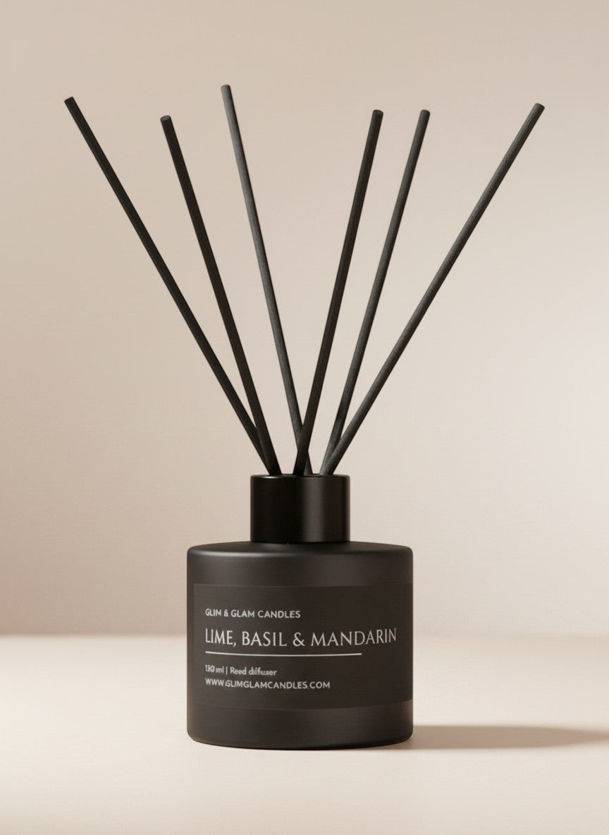 Glim & Glam Lime, Basil & Mandarin reed diffuser in a matte black bottle with black reeds on a neutral background.