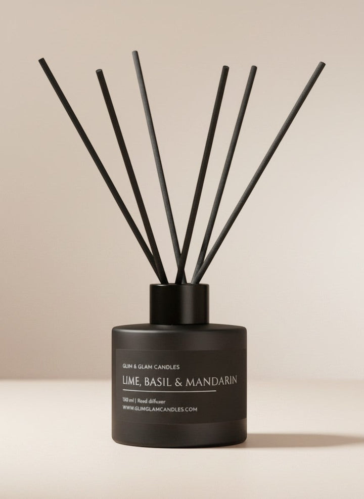 Glim & Glam Lime, Basil & Mandarin reed diffuser in a matte black bottle with black reeds on a neutral background.