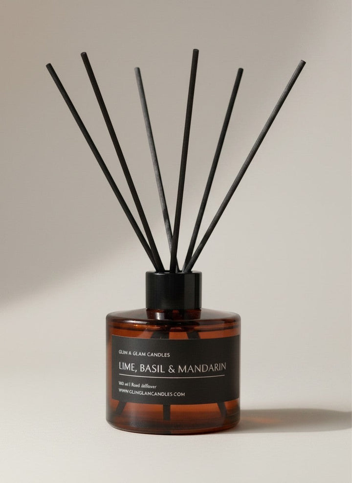 Glim & Glam Lime, Basil & Mandarin reed diffuser in an amber glass bottle with black reeds for home fragrance.