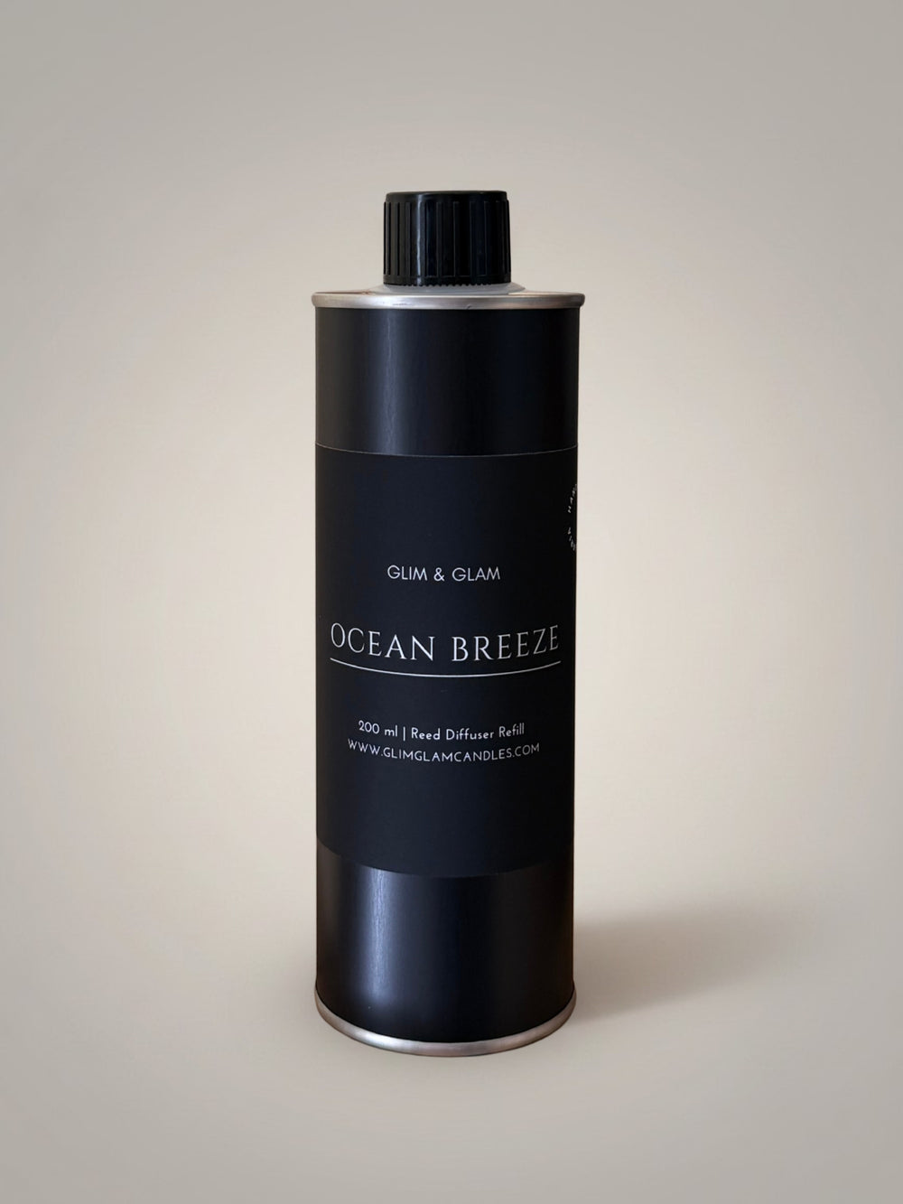 Glim & Glam Ocean Breeze 200ml reed diffuser refill bottle in a sleek black metal container.