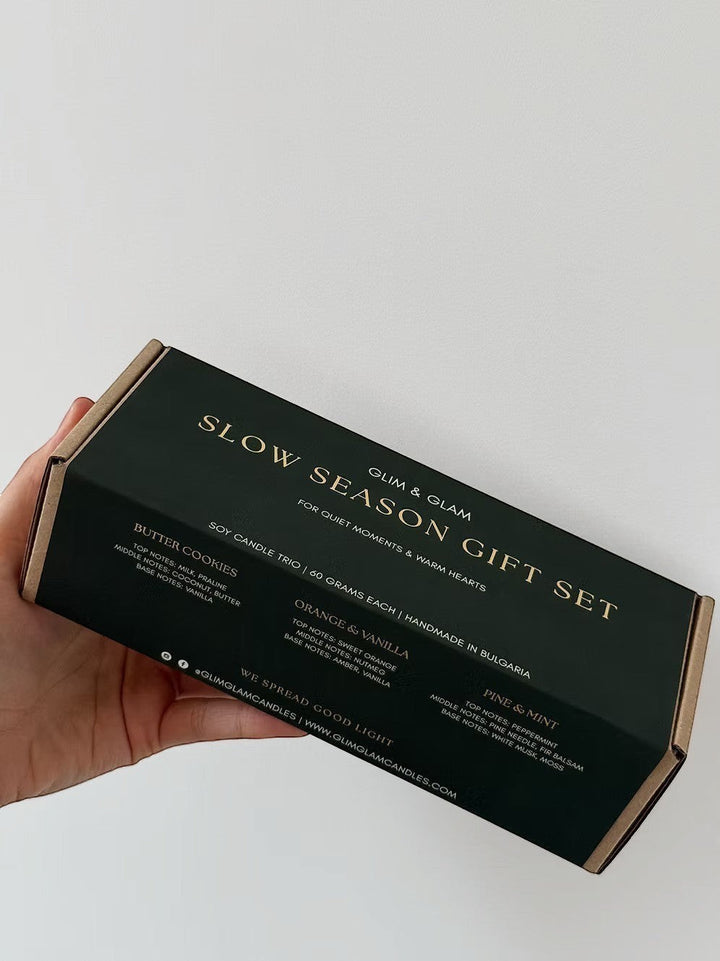 Glim & Glam Slow Season gift set box with three mini soy candles: Butter Cookies, Orange & Vanilla, and Pine & Mint.