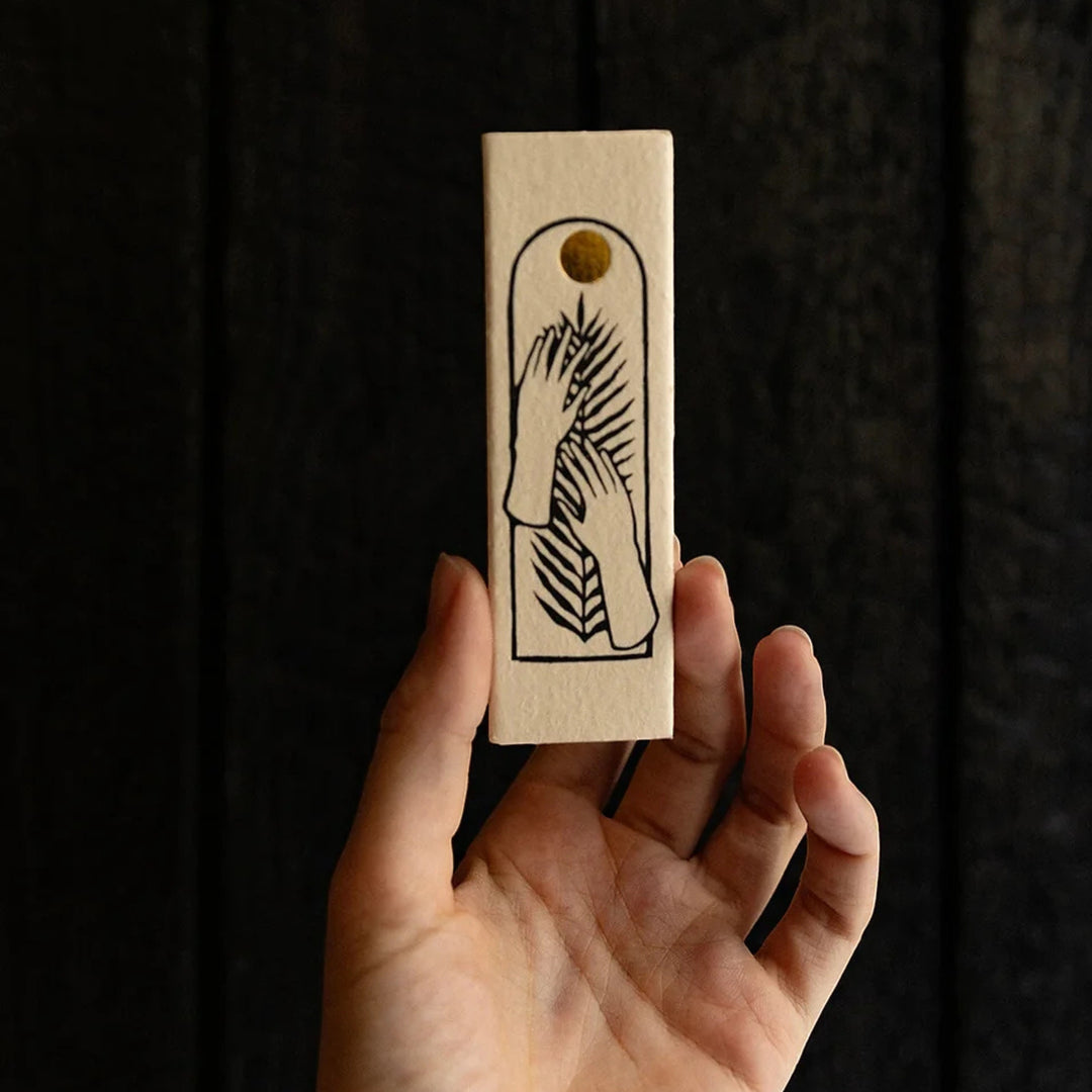 Glim & Glam SOLSTICE long candle matches with minimalist hand and palm leaf design on recycled paper.